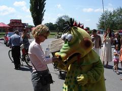 A dragon greeting a woman in a red shirt