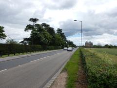 Albert Road near Shaw Farm with green fields and a cloudy sky