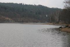 fishermen by a half-empty spring reservoir