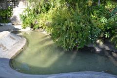 landscaped garden at Lapu Lapu monument with a small pool, benches, and trees in Cebu, Philippines