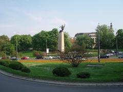 Pomnik Bohaterów Warszawy monument with green trees in the background