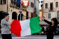 Two students with an Italian flag in Bassano del Grappa