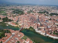 Aerial view of the historic center of Bassano del Grappa with Brenta River, Ponte degli Alpini, and town squares.