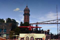 Avió del Tibidabo amusement ride at Tibidabo Amusement Park, with Torre de les Aigües de Dos Rius in the background