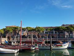 Caorle waterfront with colorful buildings and a church bell tower