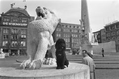 Signs on the National Monument in Amsterdam with a dog next to a lion, 1970