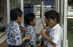 Schoolchildren around a telephone booth at the Istiqlal mosque