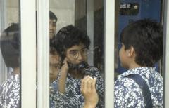 Schoolchildren in a telephone booth at the Istiqlal mosque