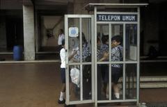 Schoolchildren around a telephone booth at the Istiqlal mosque