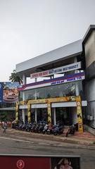 view of Kannur town with buildings, greenery and cloudy sky