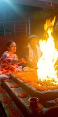 Hindu priest performing Yagna ritual with sacred fire in front of him