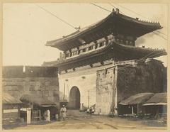 Tongdaemun (East Gate) in Seoul, South Korea, circa 1904, with trolley tracks in the foreground