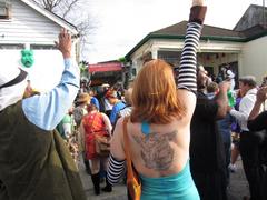 people celebrating Mardi Gras outside Backstreet Cultural Museum in New Orleans