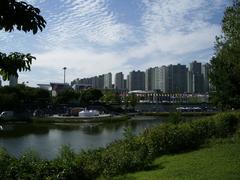 West end of Olympic Park with Peace Gate, waterside amphitheater, and flag plaza during a rock concert