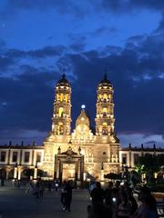 sunset at a basilica with people attending evening worship