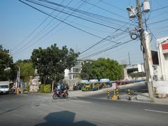 Buendia Flyover and Gil Puyat Avenue in Makati, showing Forbes Park gate and Buendia MRT Station, with SM Cyber Makati Two in the background