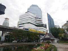 Banjasiri Park with people walking on the path, surrounded by trees and greenery