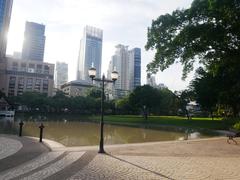 Scenic view of Benchakitti Park with lake and cityscape in Bangkok