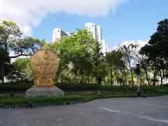 Sculpted water fountain in the middle of Benjasiri Park with skyscrapers in the background