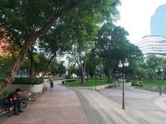 Banjasiri Park in Bangkok with a serene lake and nearby buildings in view