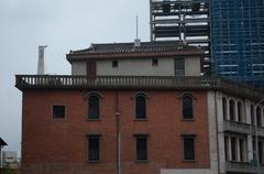 A three-story building with a platform on the roof for overlooking, characterized by a combination of Chinese and Western architectural styles.