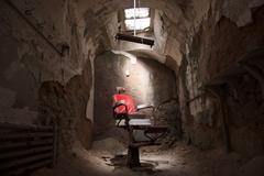 prison barber's chair in a rotting chamber