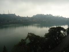 Serene evening at Bhimtal lake with boats and mountains