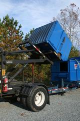 Blue Allied Waste Services dumpster lifted on an International truck