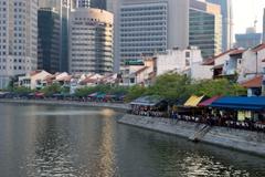 Boat Quay along the Singapore River with historic buildings and modern skyscrapers