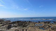 Praia do Castelo do Queija with clear blue waters and scenic views