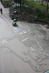 Phoenix art installation with paving and ceramic stones by Hartmut Mumme in Wallanlagen park, Hamburg