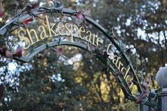 entrance to Shakespeare Garden with stone path and lush greenery