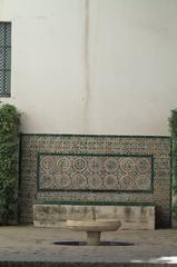 patio with fountain and azulejos decorated bench in Real Alcázar of Sevilla