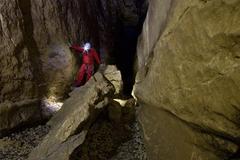 Speleologist leading a group in Fontanazzi area at Buso della Rana