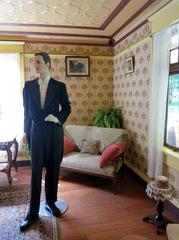 Gentleman caller seated on a vintage sofa with a telephone