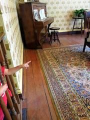 Curious baby pointing and asking their mother a question in a living room