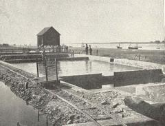 Basin of degorgement in Marennes with oyster tramway and Soudre in the background