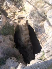 Steep entrance of the Nympholeptus Cave with carved steps