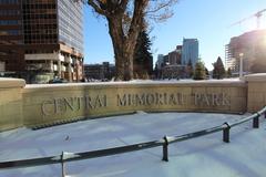 Central Memorial Park in Calgary with a pathway, trees, and benches