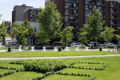 Central Memorial Park with lush green lawn, trees, and a central monument