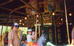 me and Geoffrey on the carousel wearing a Blue Jays cap