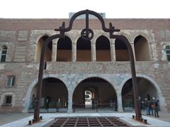 Palau dels Reis de Mallorca courtyard with wellhead and west facade