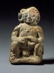 Boy feeding a parrot terracotta sculpture from 1st century B.C. Chandraketugarh, West Bengal, India