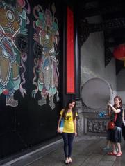 Chinese woman posing for a photo in front of the Chen Clan temple gate in Guangzhou