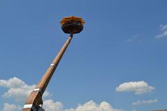 view of an amusement park ride called Isolavolante against a bright blue sky