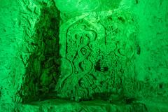 Ancient carvings on the walls of Chislehurst Caves in Kent