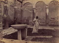 Youth wearing a toga in the patio of the Casa degli Archi in Pompeii by Wilhelm von Gloeden