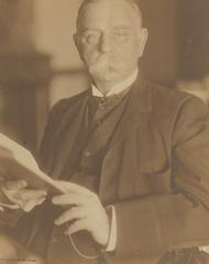 John G. Johnson holding a book