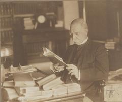 John G. Johnson seated at desk at age 66