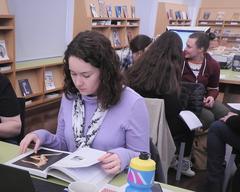 New editor studying a book in museum library